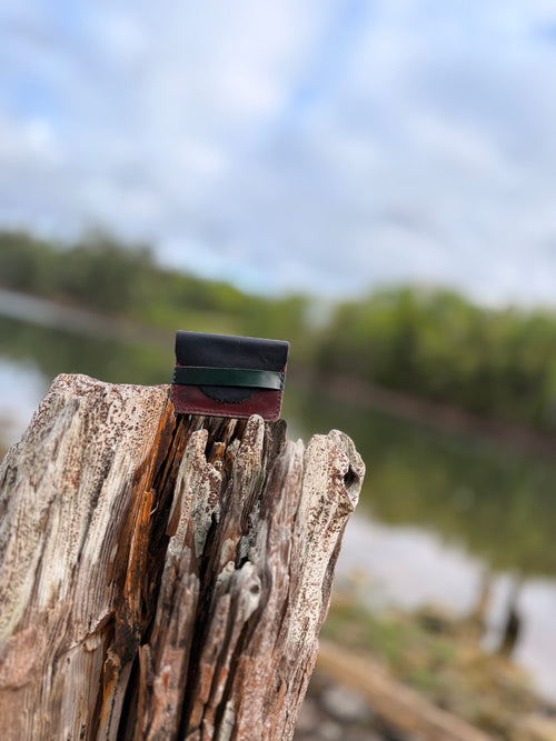 Two-tone stacked leather card wallet in black, green, and oxblood