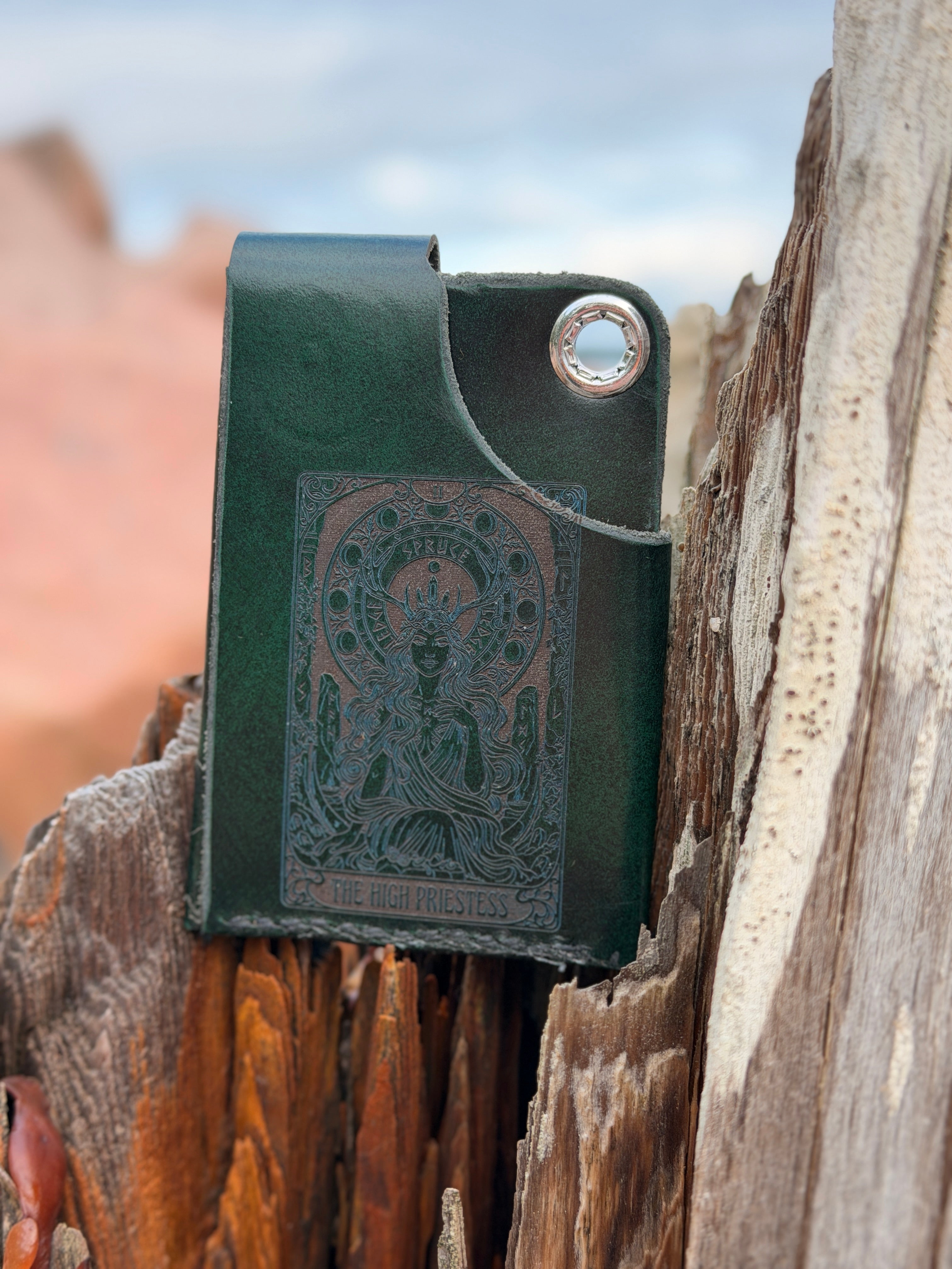 Forest green leather pouch with embossed tree logo