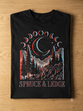 Crescent Moon Phases tee flat-lay on wood