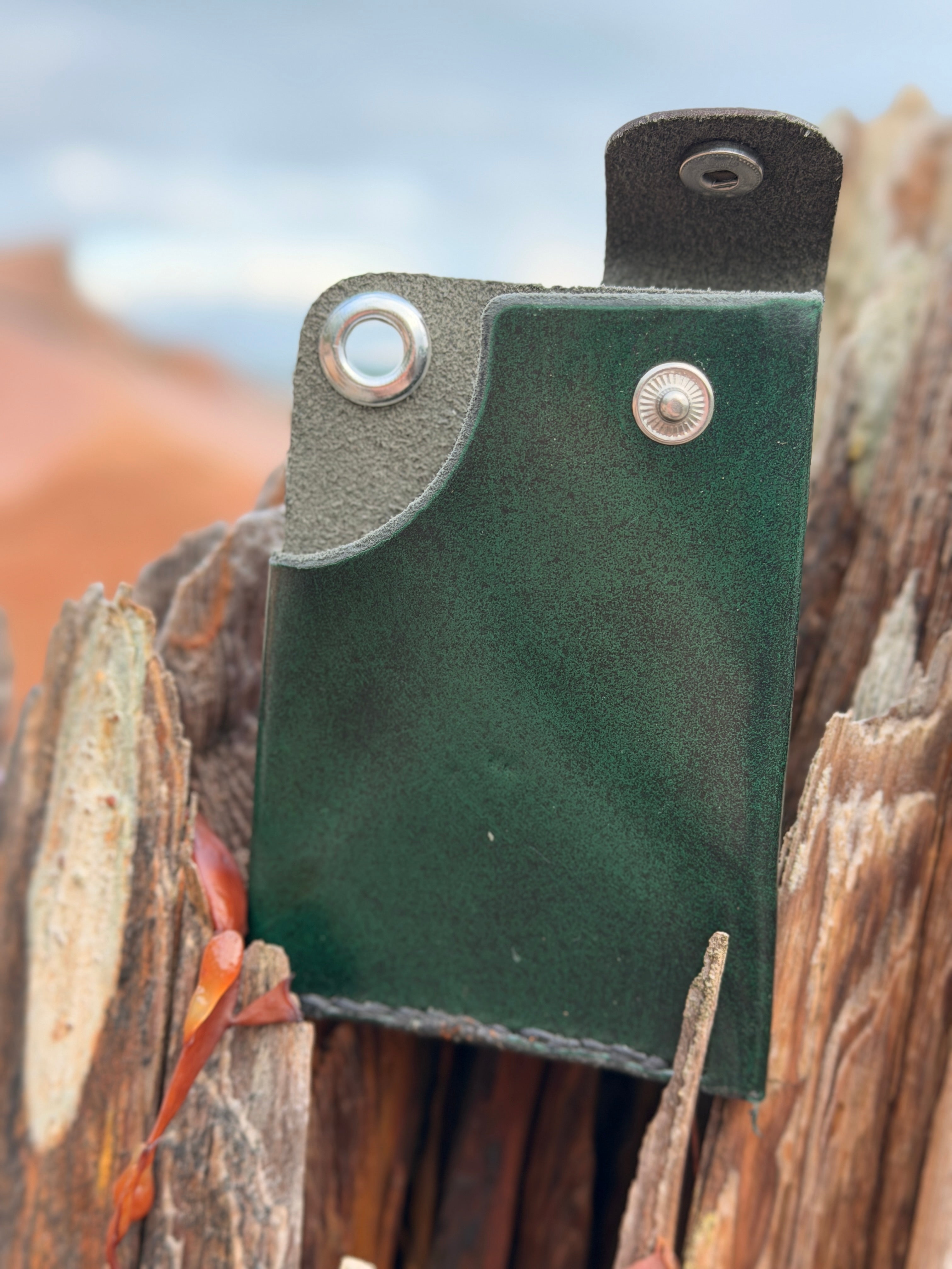 Forest green leather pouch with snap and eyelet, handmade in Maine